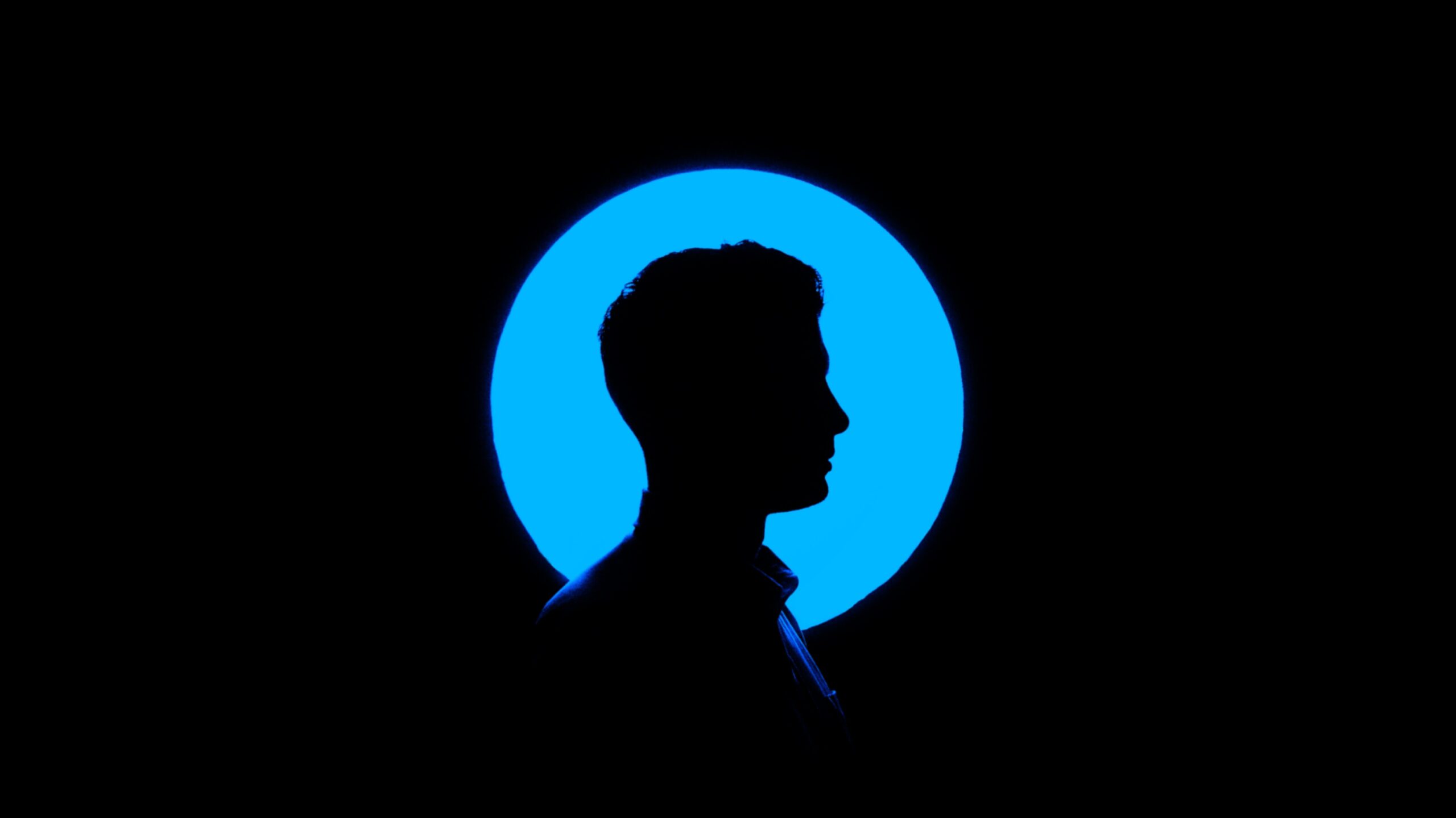 dark room profile face in blue background feat
