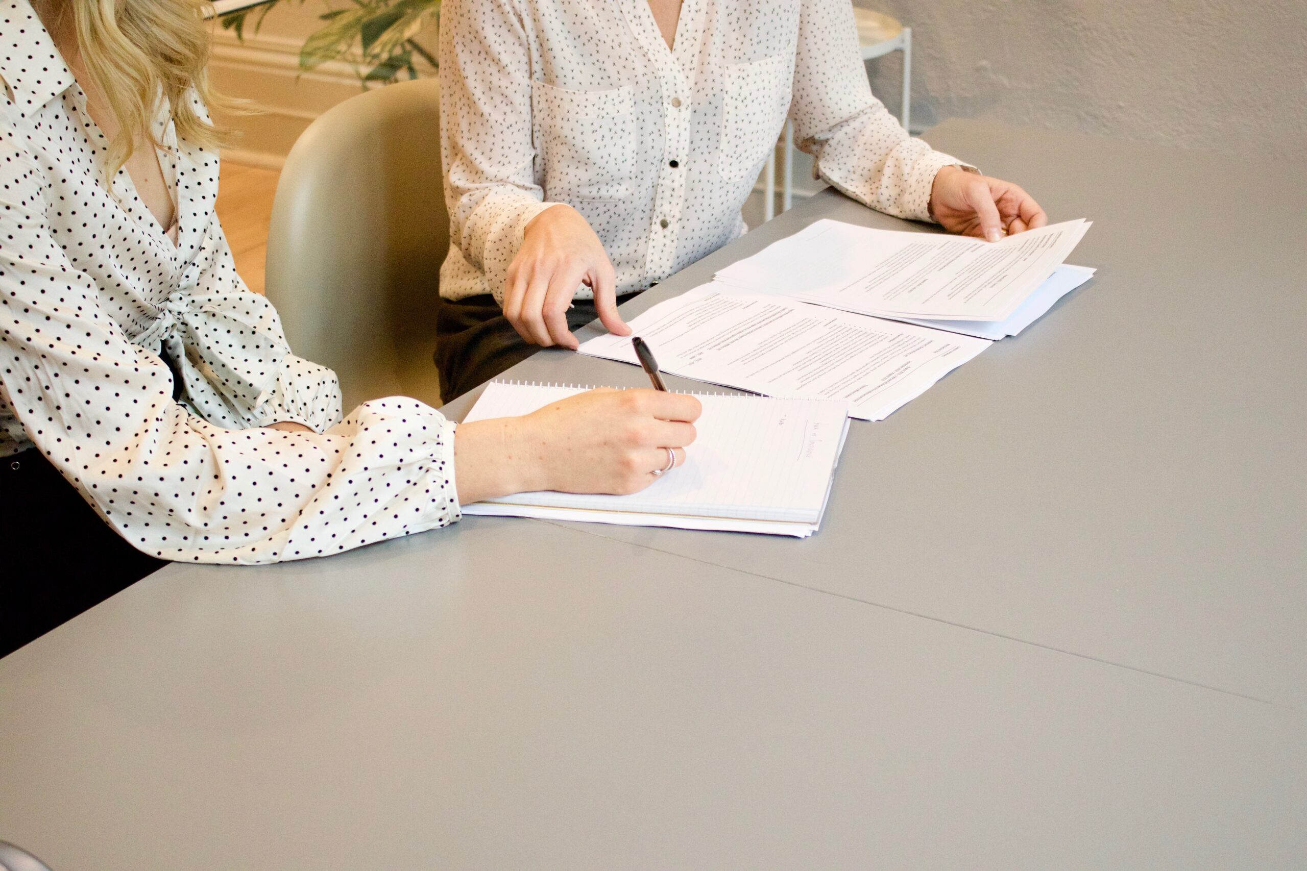 woman signing documents on PDF Printed papers